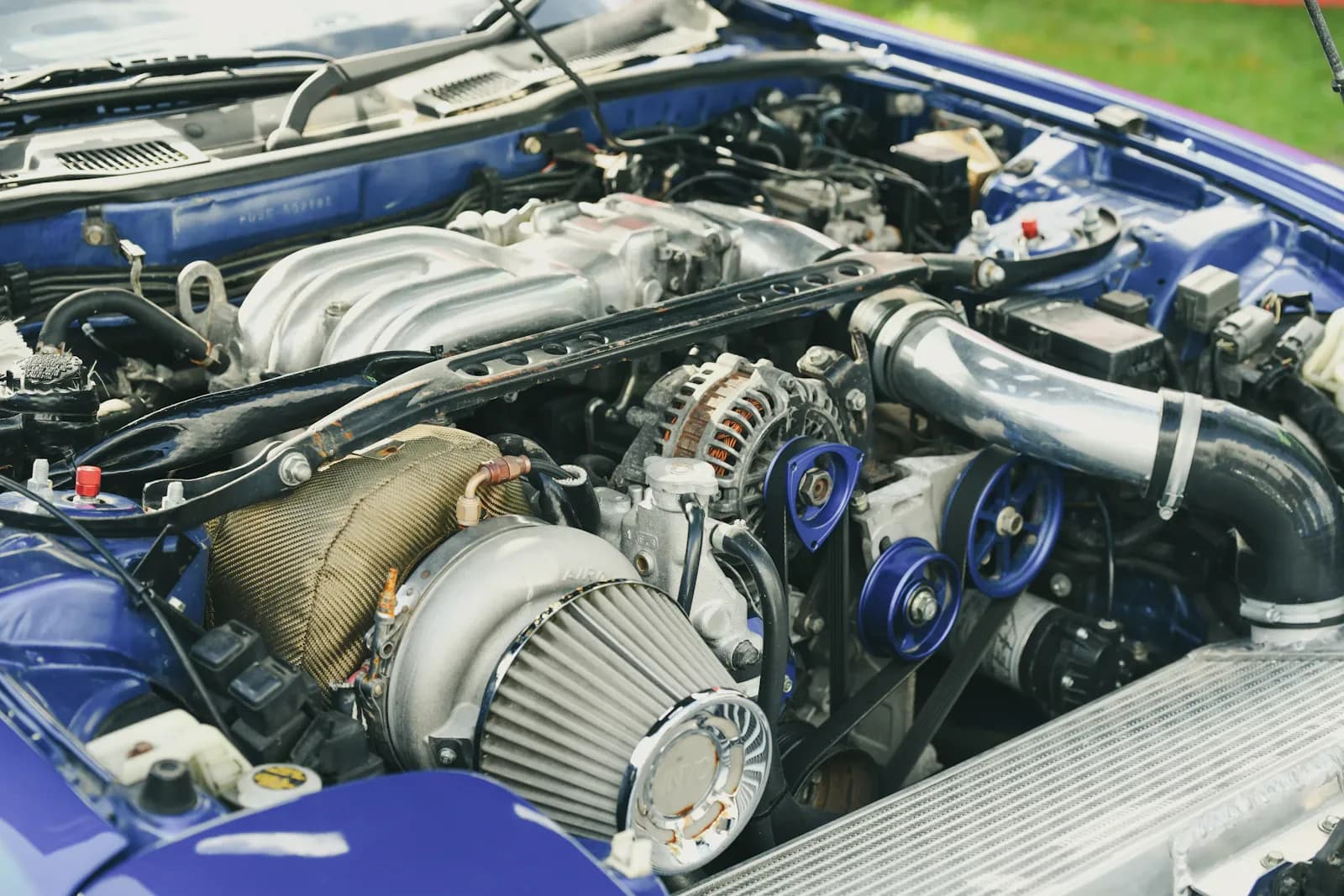 Close-up of a turbocharger installed in a modified engine bay